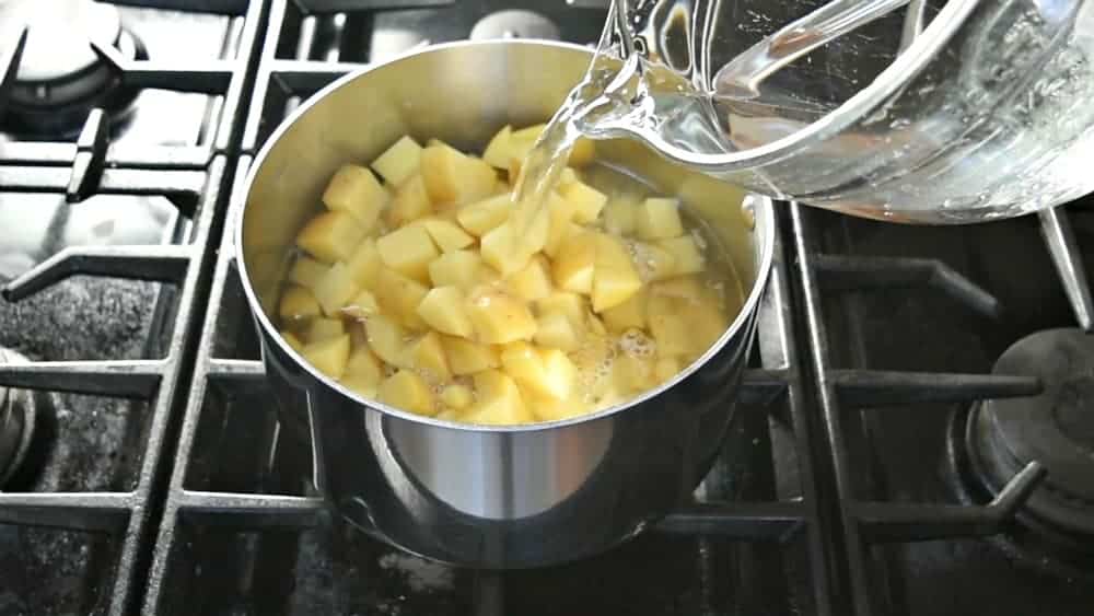 Adding water to cover potatoes