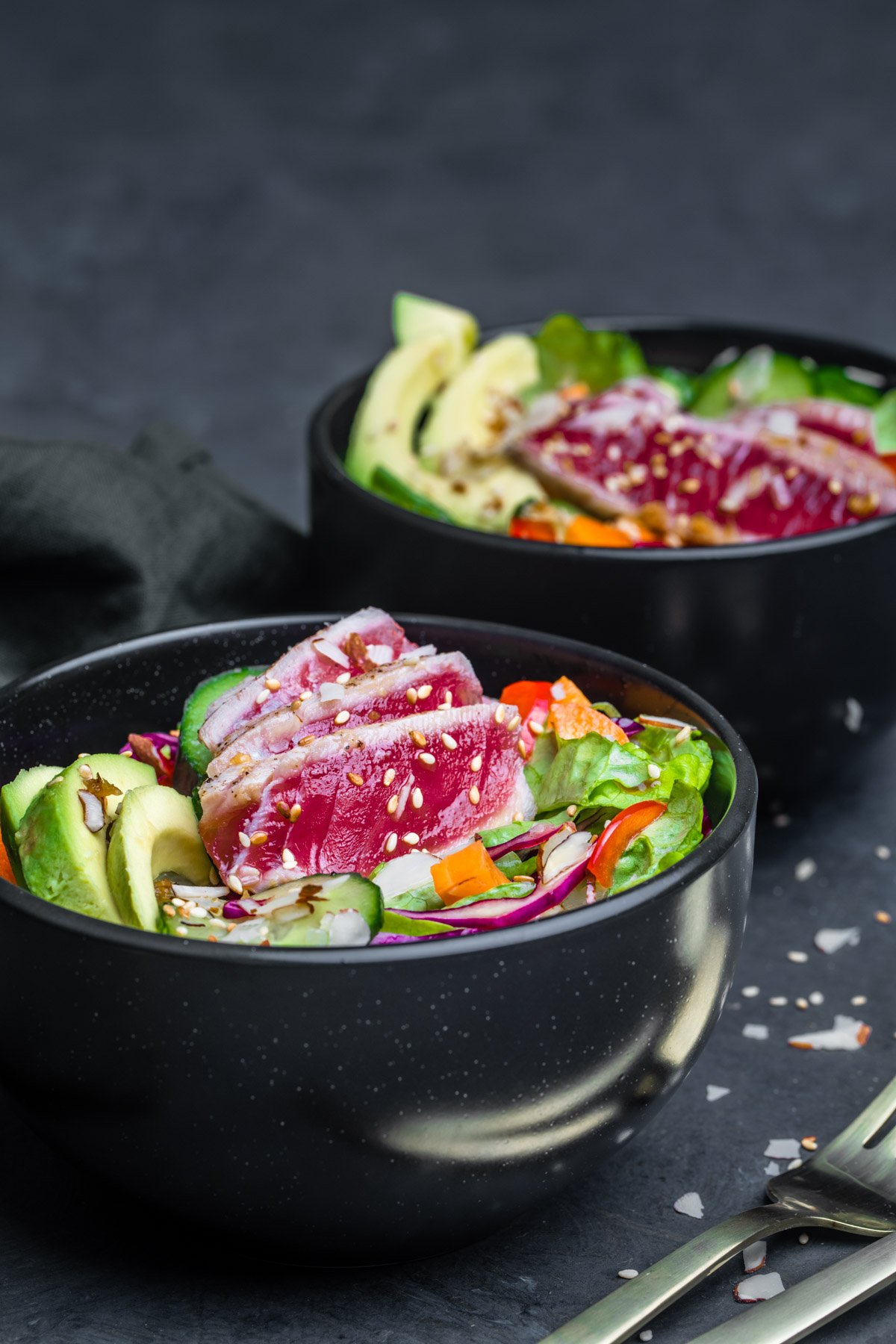 Ahi Tuna Salad served in a black bowl and photographed at an angle.