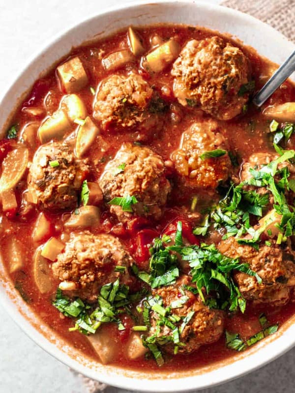 Albondigas Soup served in a white bowl and photographed from overhead.