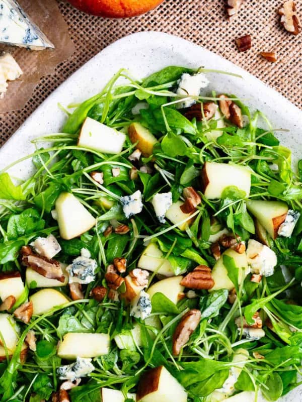 Apple Pecan Salad served on a speckled white platter.