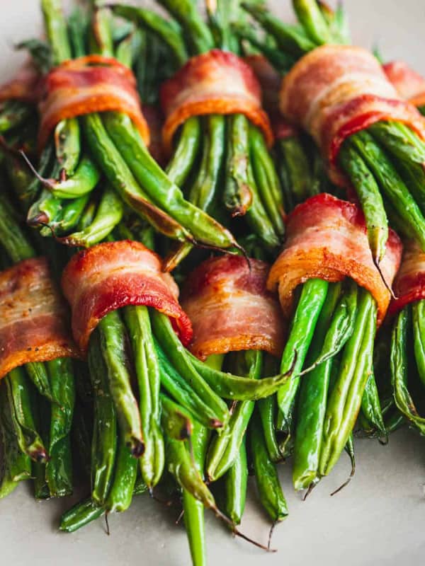 Bacon Wrapped Green Beans served on a white plate.