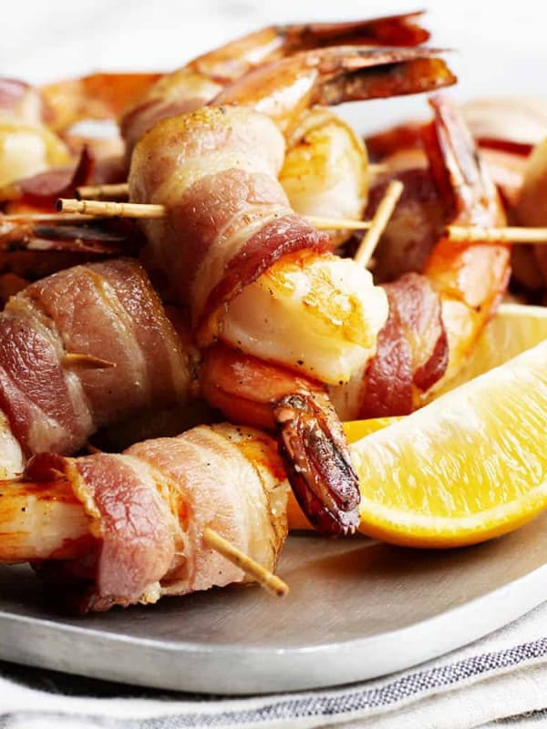 Bacon Wrapped Shrimp served on a stainless platter featured