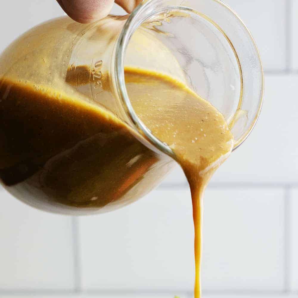 pouring balsamic vinaigrette from pitcher