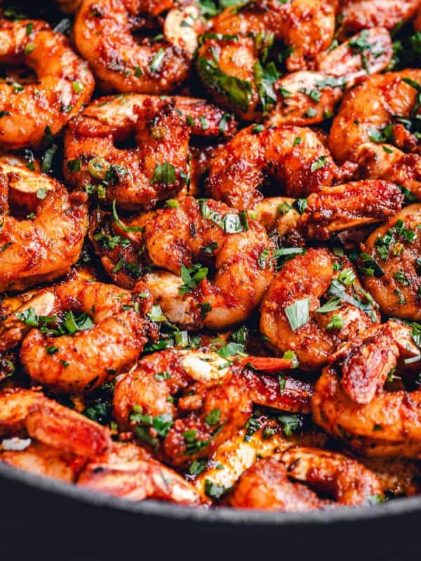 Close up angle shot of Blackened Shrimp in a large skillet.