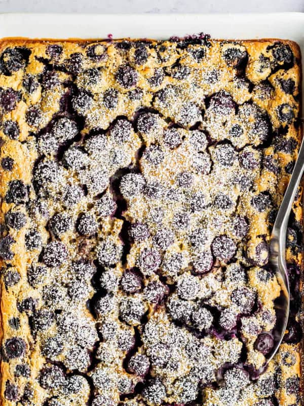 Blueberry Clafoutis in a white baking dish ready to serve.