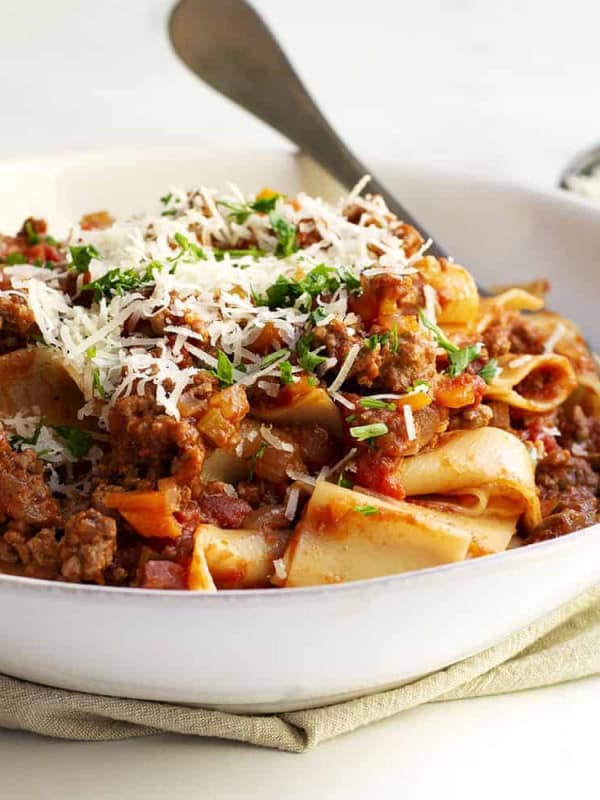 Bolognese Sauce with pappardelle served in a shallow white bowl