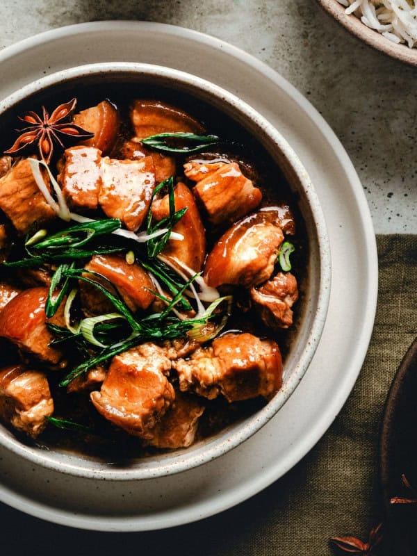 Braised Pork Belly served in a white ceramic bowl and photographed from overhead.