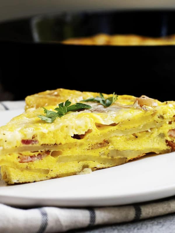 breakfast frittata wedge served on a white plate