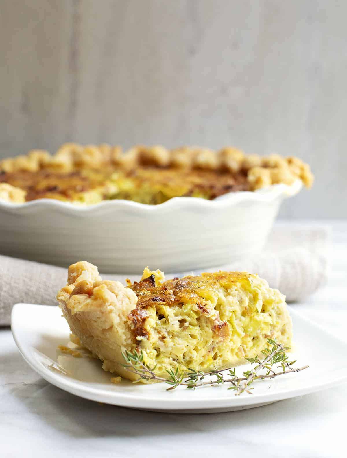 a slice of Breakfast Quiche served on a square white plate