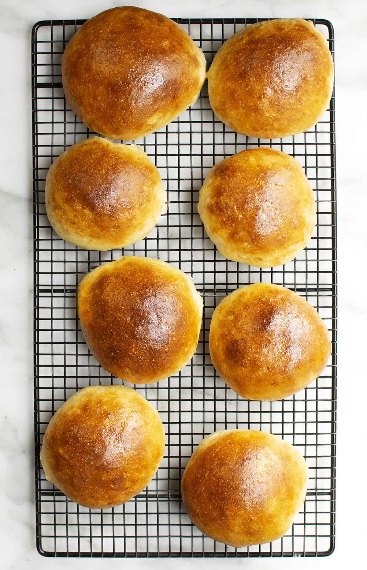 brioche buns on black wire cooling rack