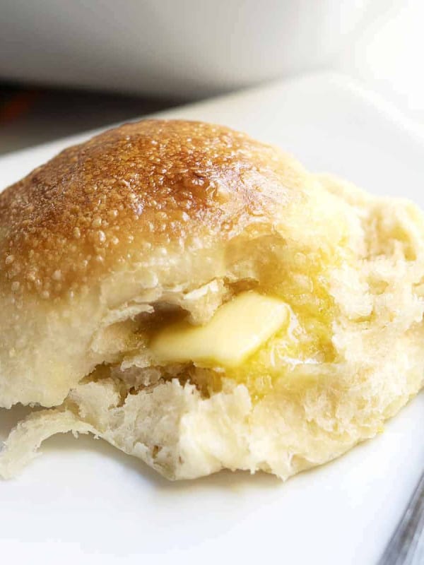 Brioche Roll served on a white plate with butter