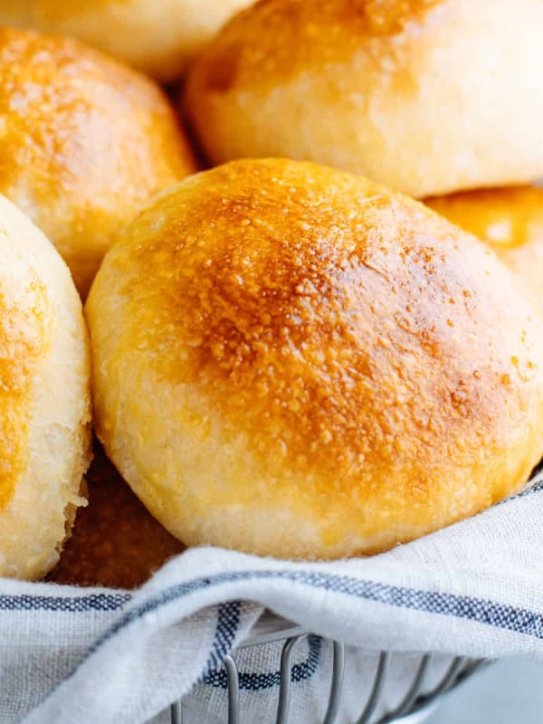 Brioche Slider Buns served in a wire basket lined with a cloth towel.