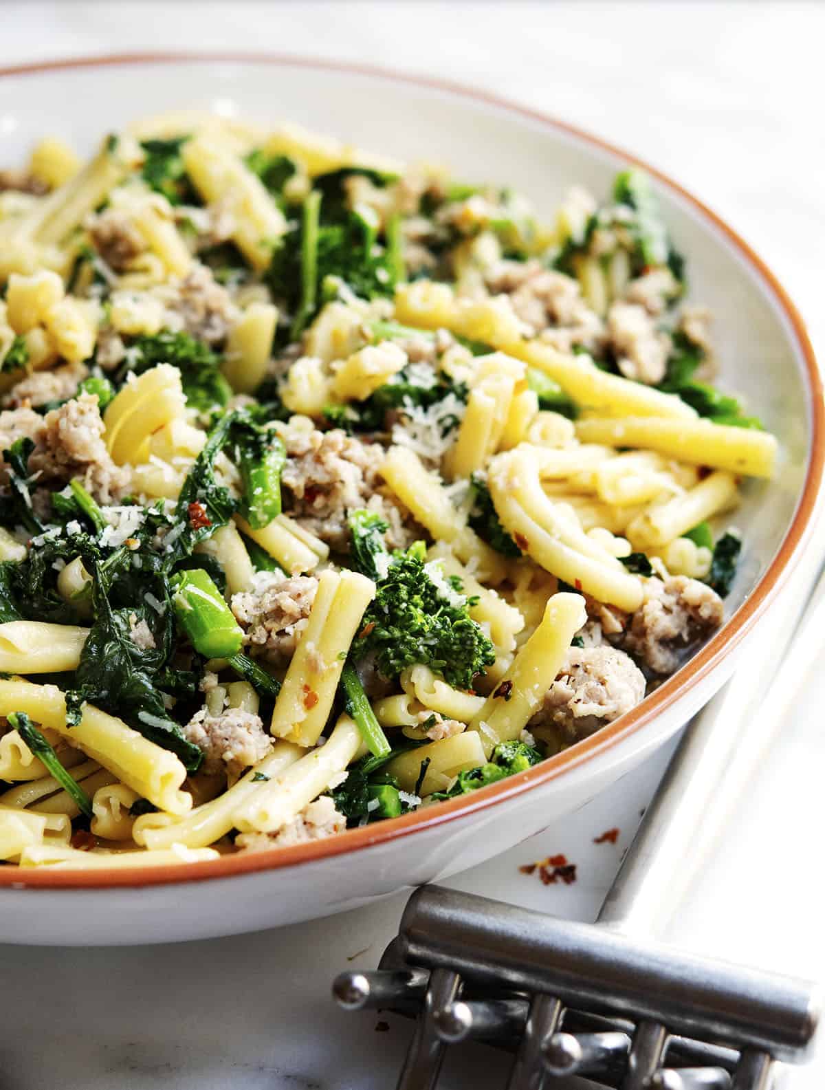 Broccoli Rabe and Sausage Pasta served in a white ceramic bowl