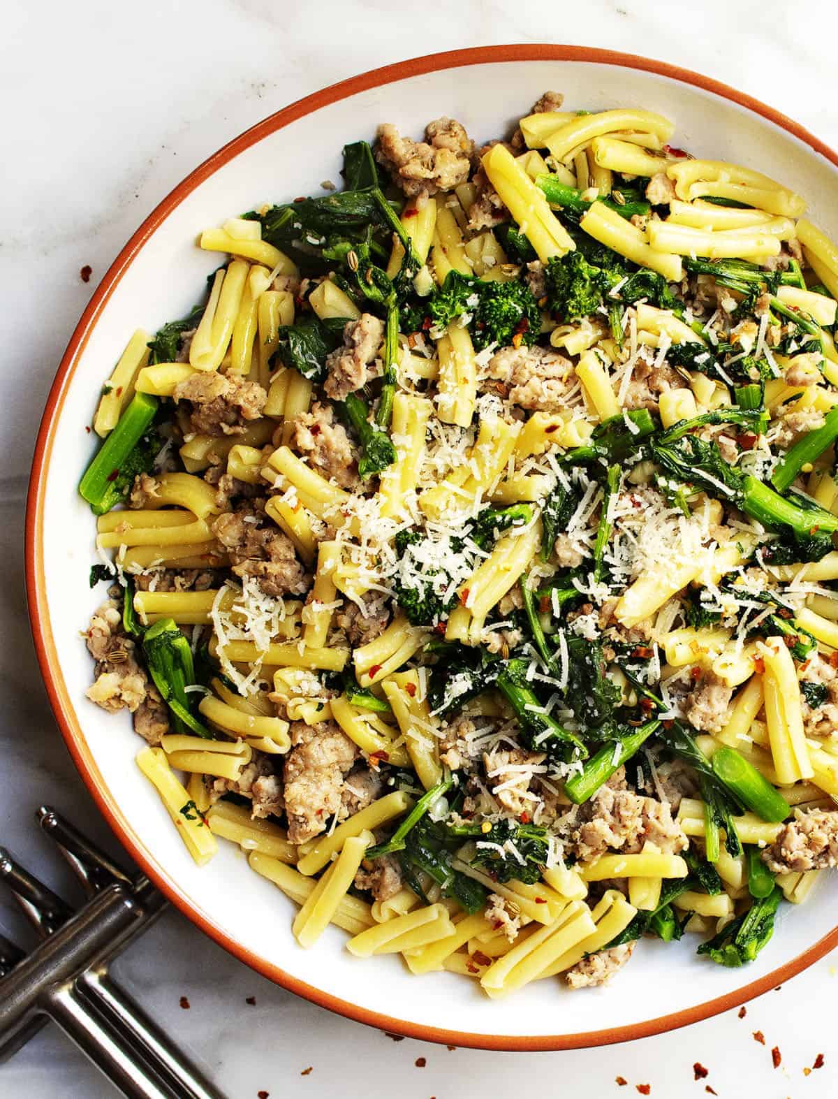 Broccoli Rabe and Sausage Pasta served in a white bowl photographed from above