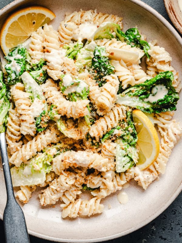 Caesar Pasta Salad served in a cream ceramic bowl.