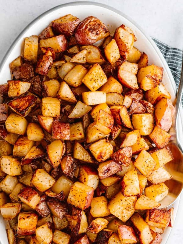 Cajun Potatoes served on a white oval platter photographed from above.