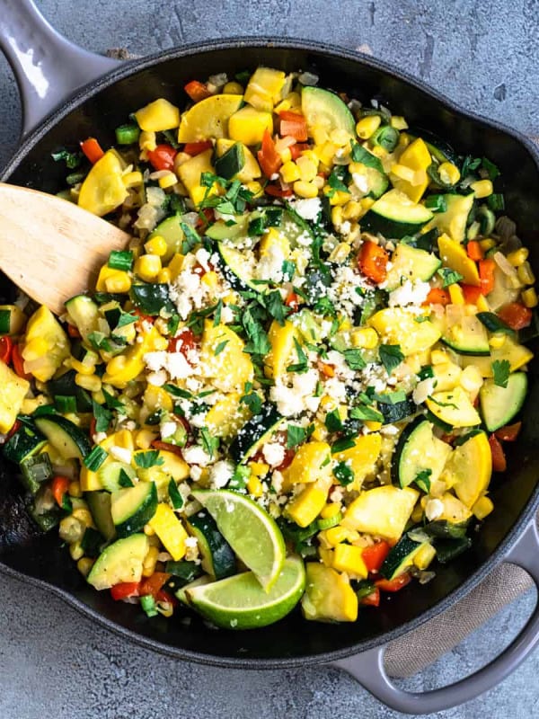 Calabacitas served in a cast iron skillet and photographed from overhead.