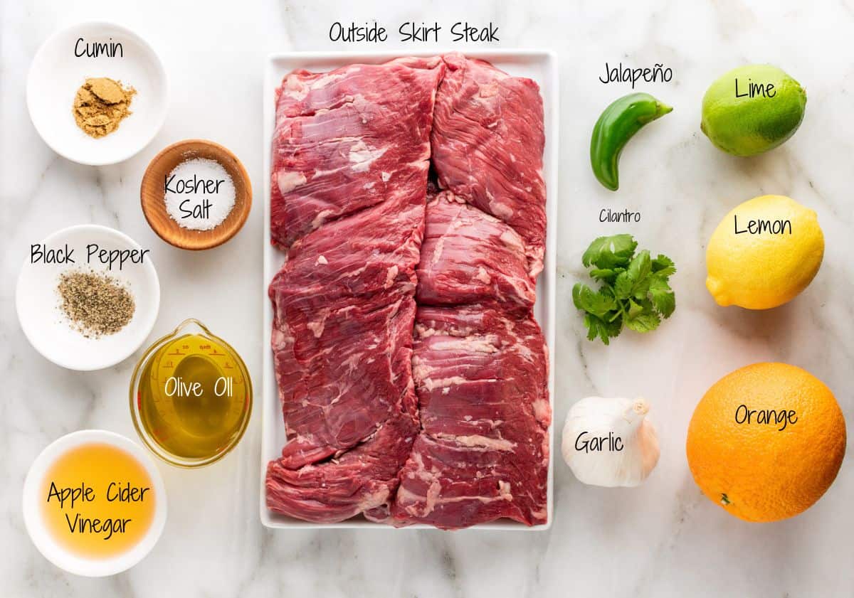 Carne Asada Ingredients on a white marble board.