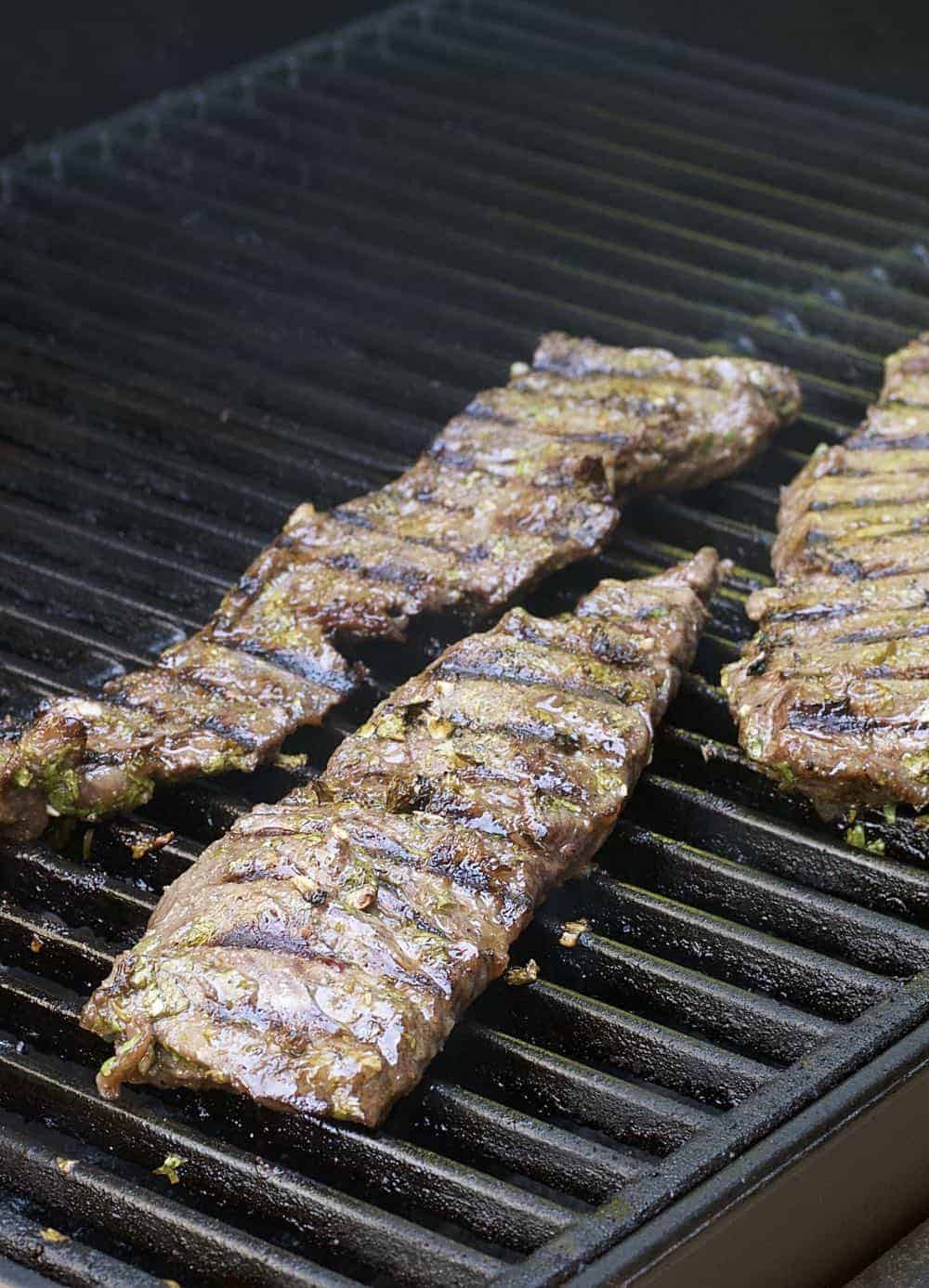 Carne asada cooking on the grill.