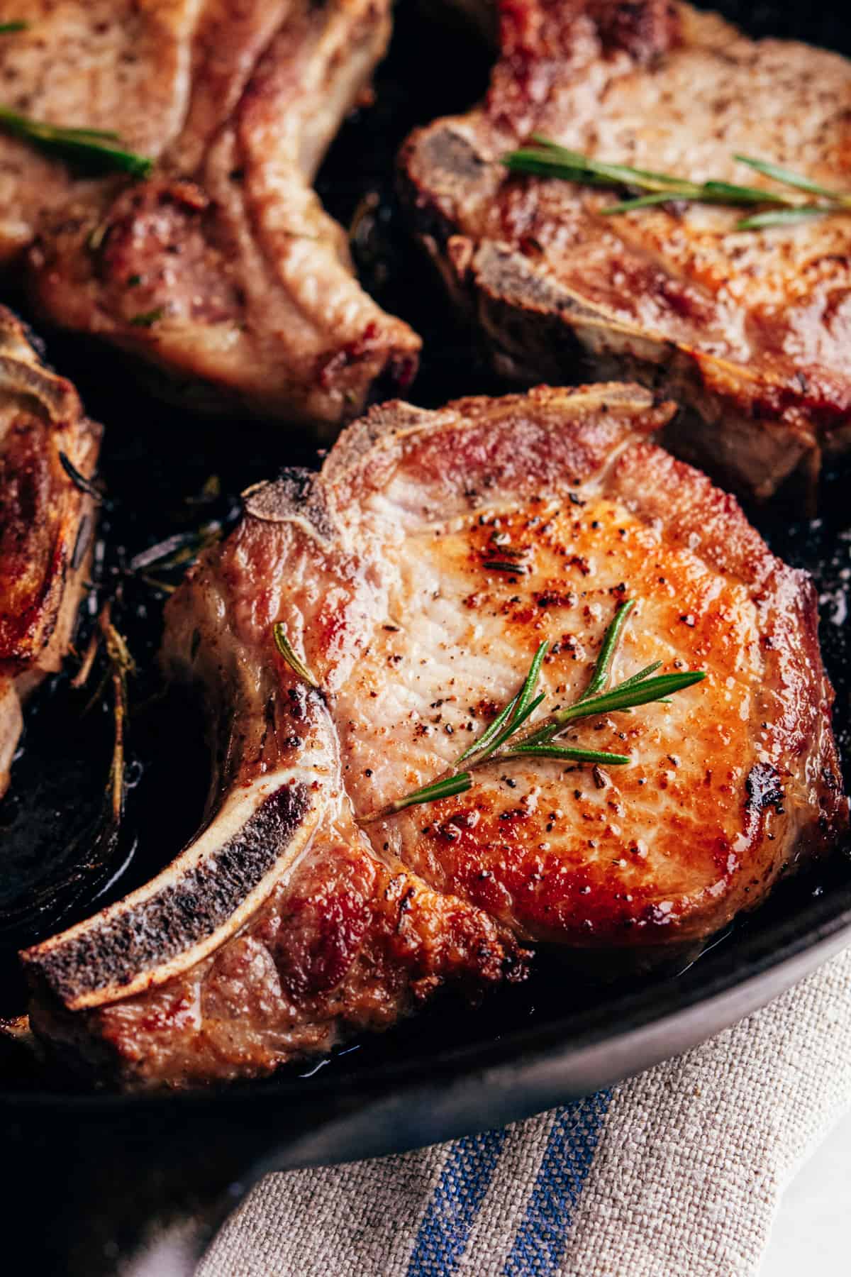 seared pork chops in a cast iron pan.