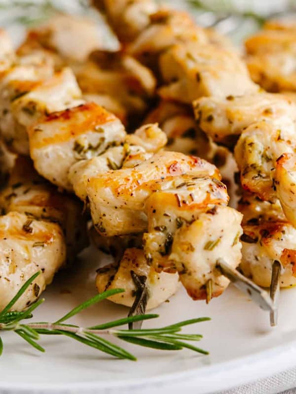 Chicken Kabobs cooked in the oven served on a white oval platter with a linen napkin