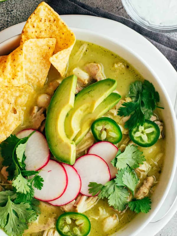 Chicken Pozole Verde served in a white bowl.