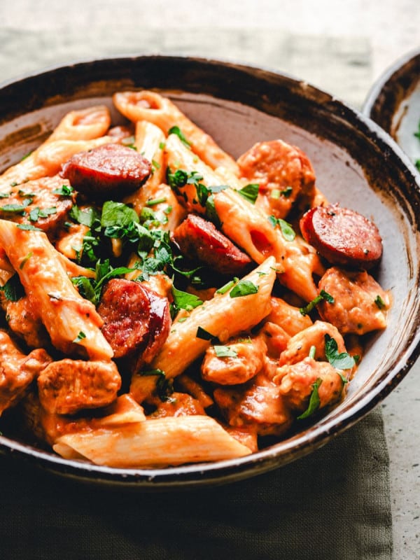 Chicken and Sausage Pasta in a ceramic bowl photographed at an angle.