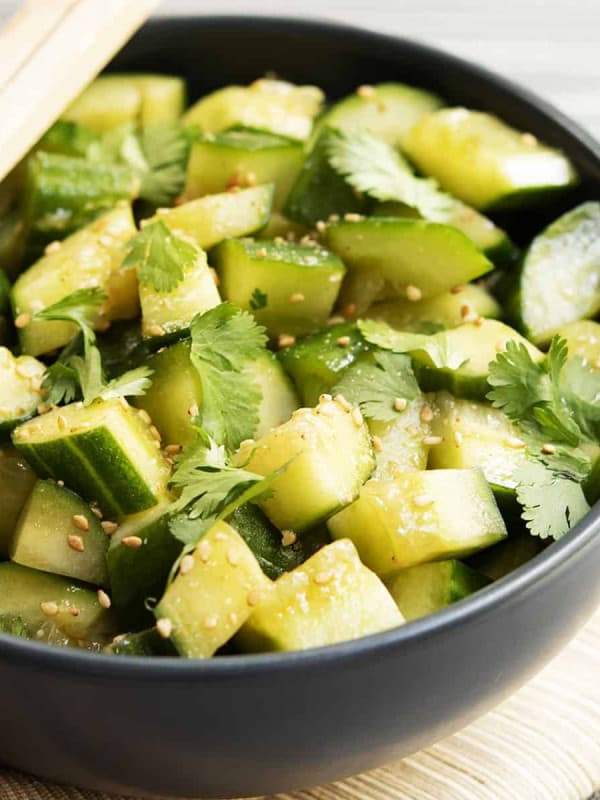 Chinese Cucumber Salad served in a charcoal bowl with chopsticks