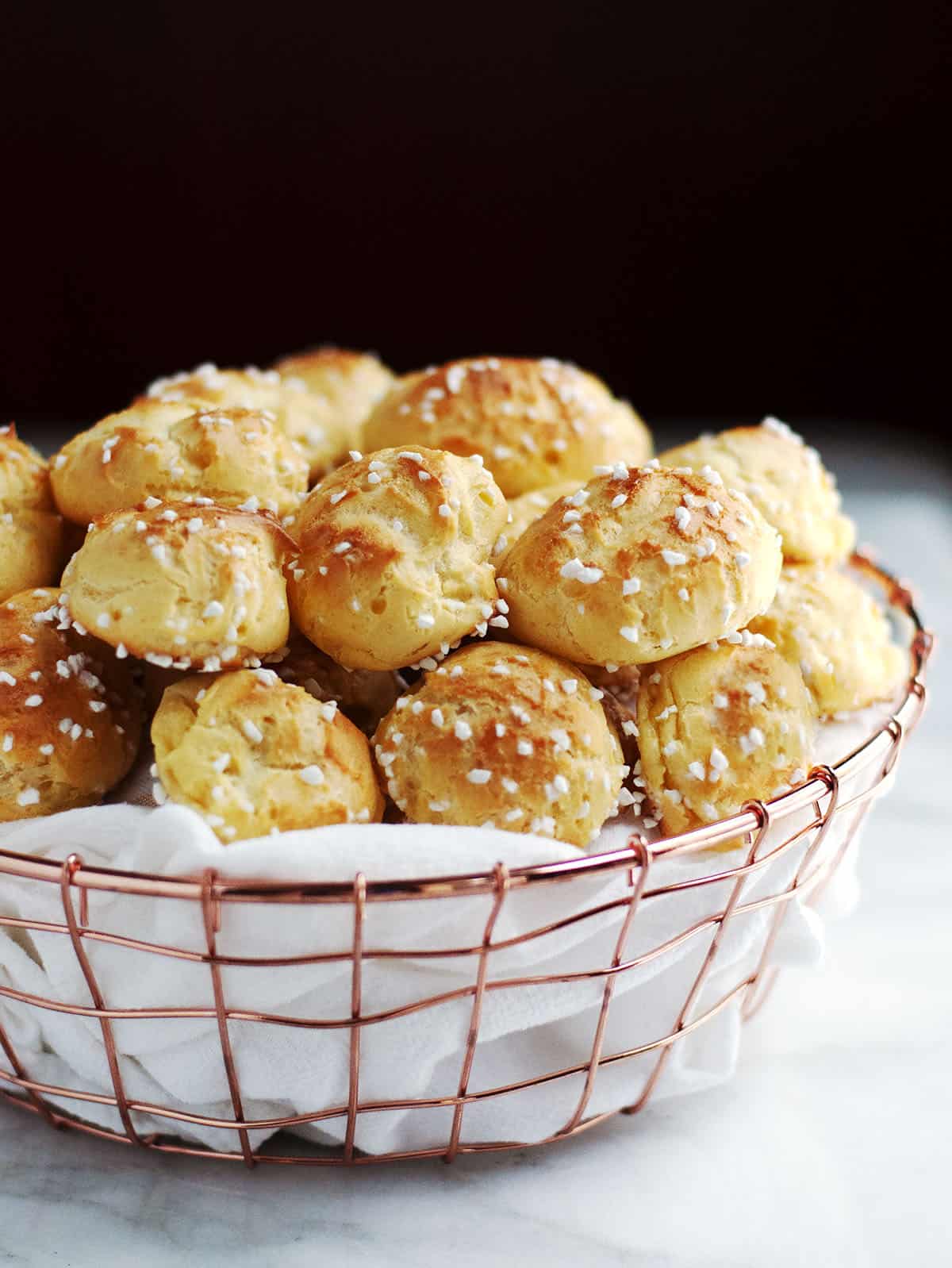 Choquettes served in a cloth lined copper basket