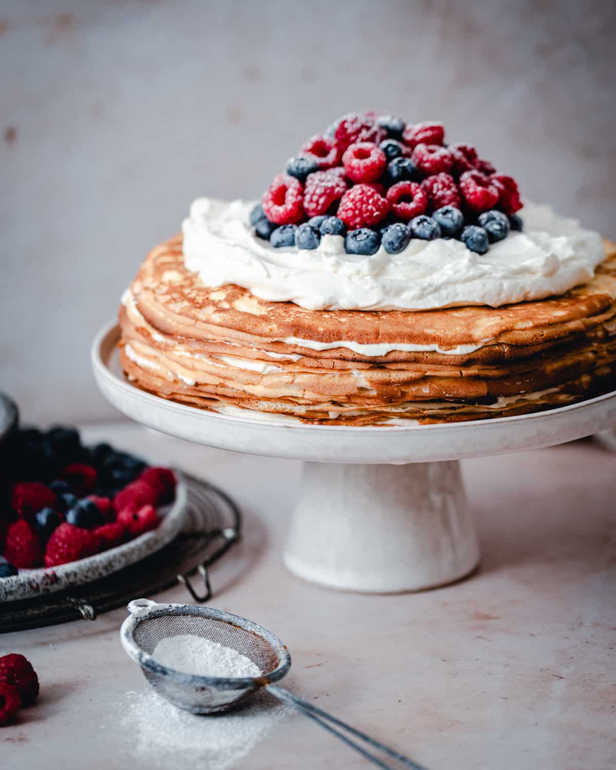 Crepe Cake served on a white ceramic cake plate.