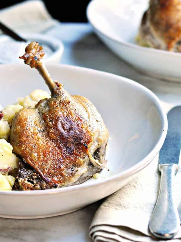 Easy Duck Confit Served in Shallow Bowls with mashed potatoes featured