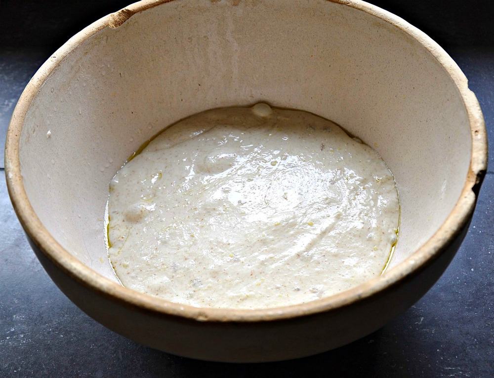 English Muffin Dough rising in a stoneware bowl