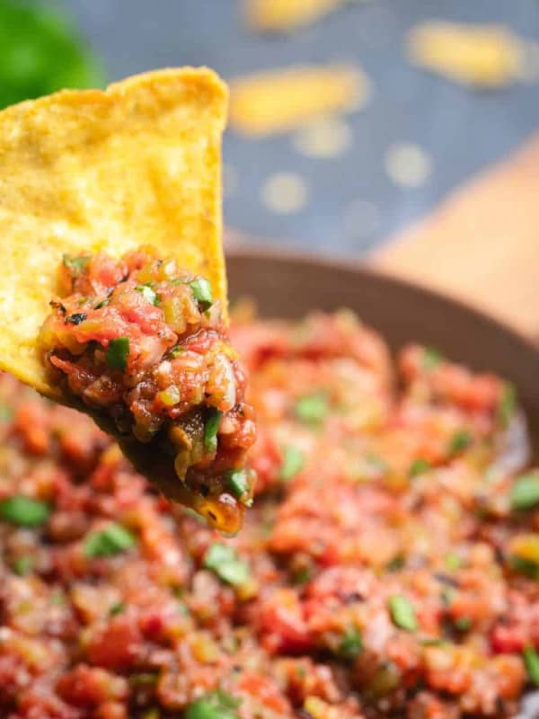 Fire Roasted Salsa scooped on a yellow corn tortilla chip.