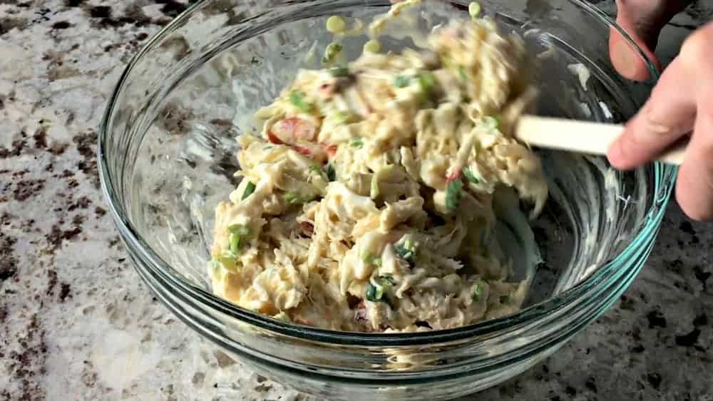 Folding wet ingredients into lump crab