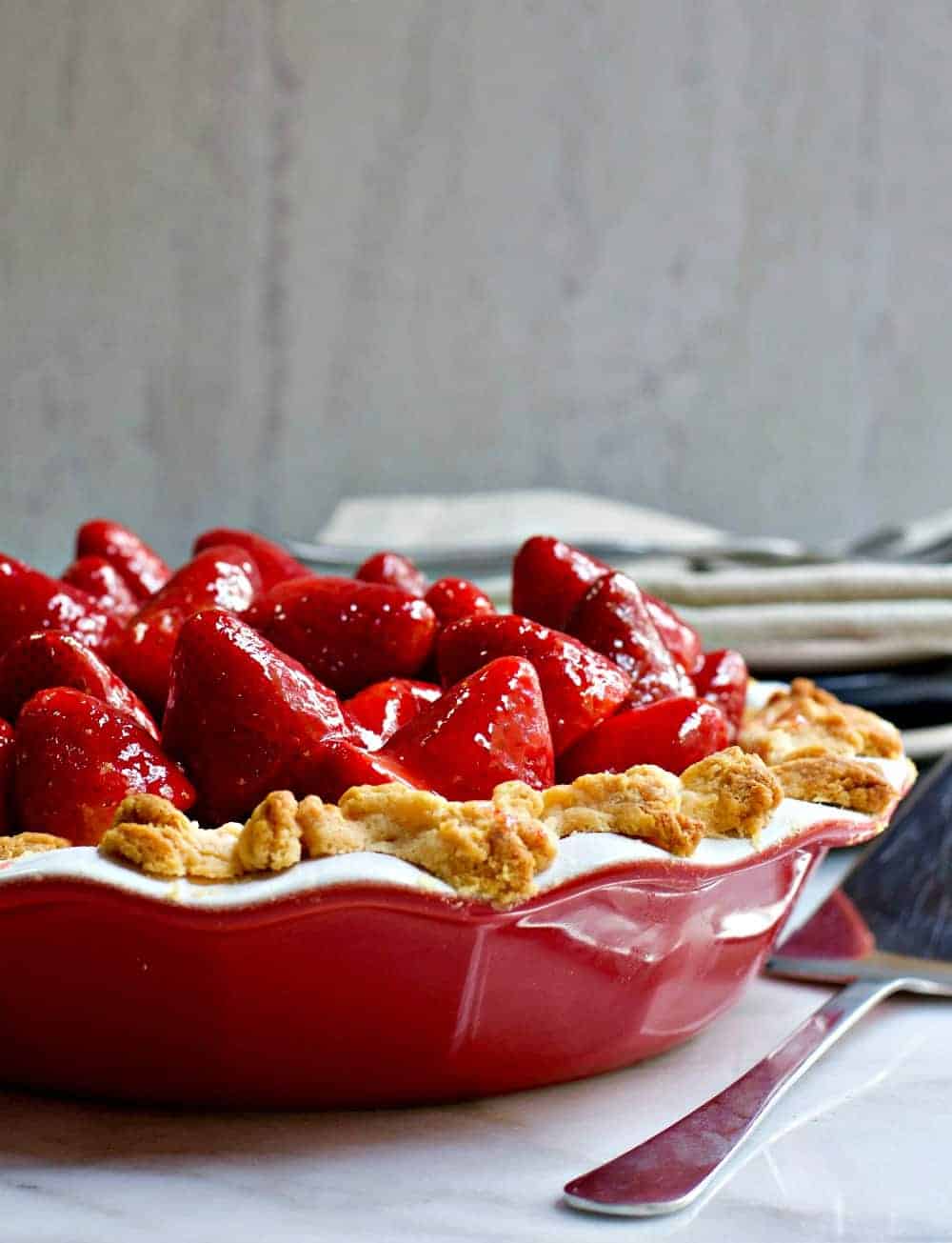 Fresh Strawberry Pie served in a red ceramic pie pan