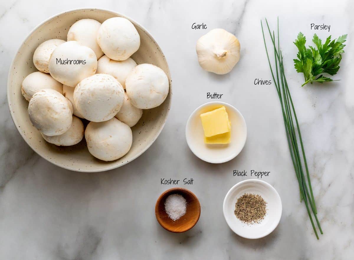 Garlic Butter Mushrooms Ingredients on a white marble board.