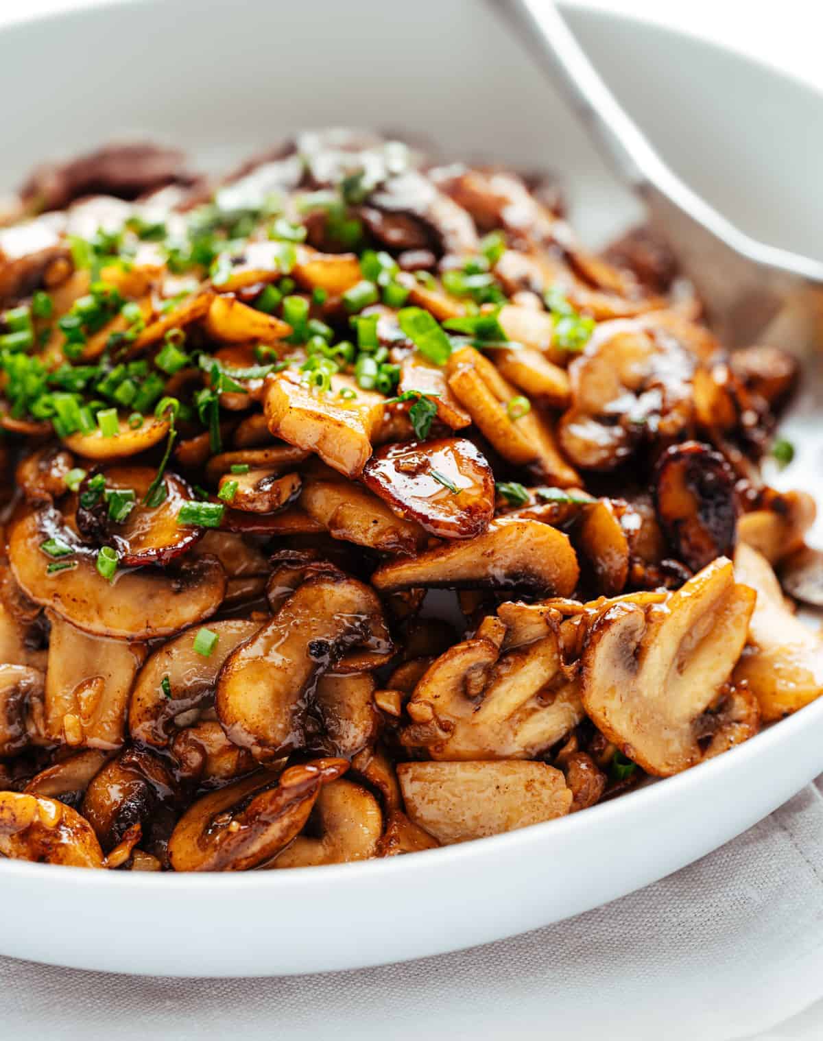 Garlic Butter Mushrooms served in a white bowl.