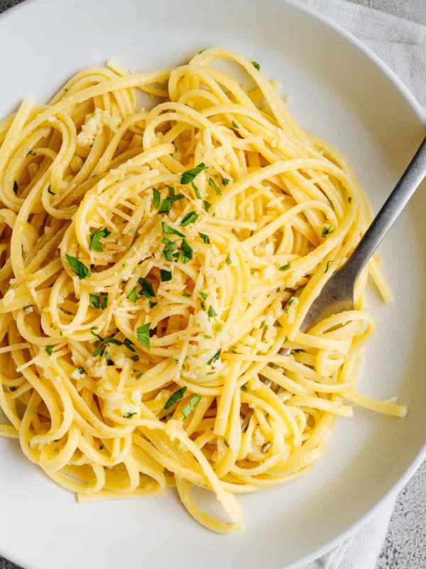 Garlic Butter Noodles served in a white bowl and photographed from above.