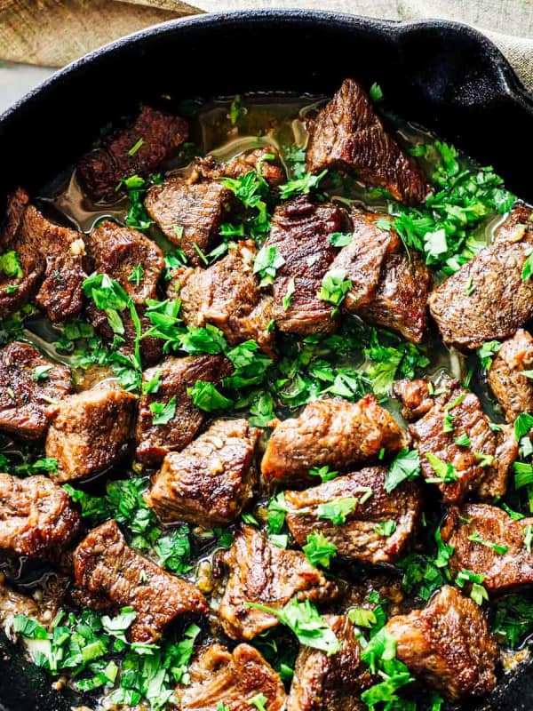 Garlic Butter Steak Bites in a cast iron skillet photographed from overhead.