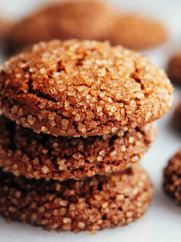 Gingersnap Cookies stacked on a white marble board.