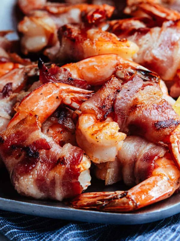 Grilled Bacon Wrapped Shrimp served on a stainless steel platter.