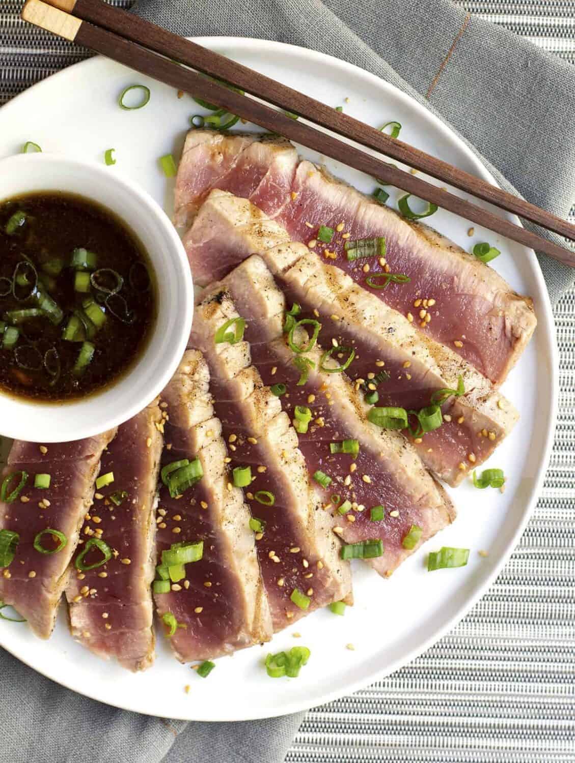 Grilled Tuna Steaks served on a white plate photographed from above