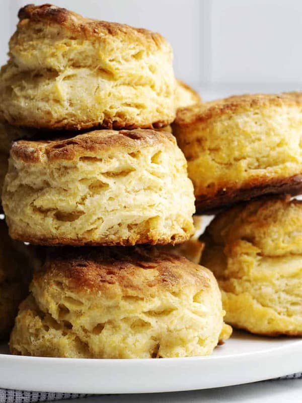 Homemade Biscuits stacked on a white plate