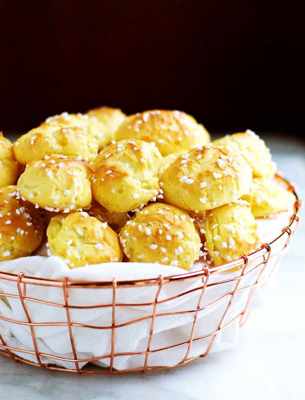 Homemade-Chouquettes-French-Pastry-Sugar-Puffs served in a wire basked