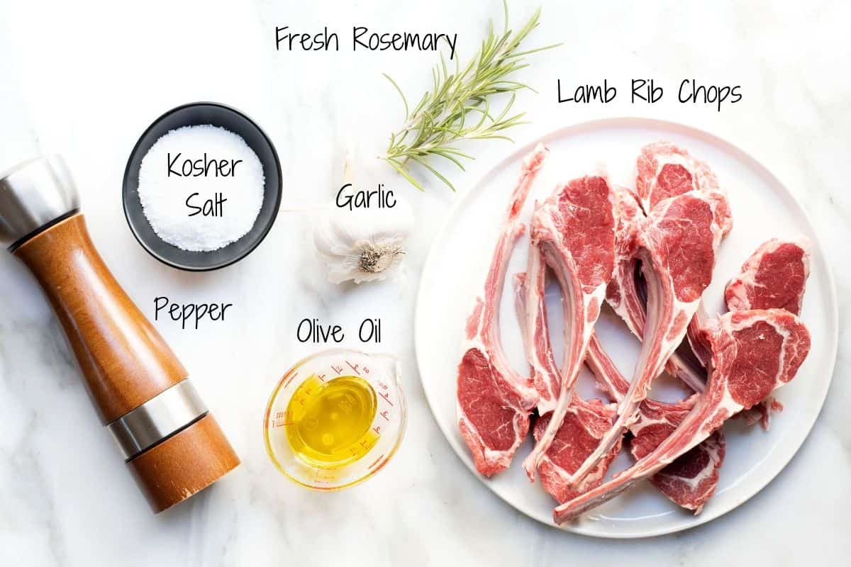 Ingredients for Grilled Lamb Chops on a white marble board