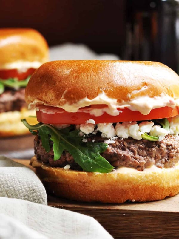 Lamb Burgers served on a wooden board