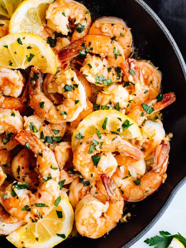 Lemon Garlic Butter Shrimp with lemon slices in a cast iron skillet