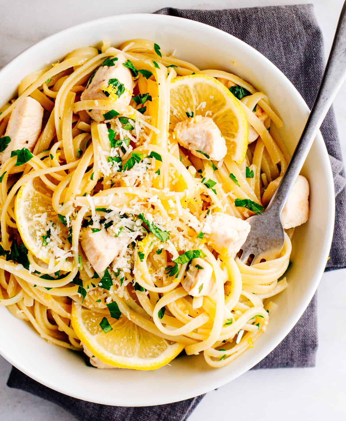 Lemon Garlic Chicken Pasta served in a white bowl photographed from above.