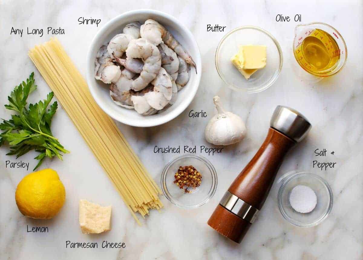 ingredients for Lemon Garlic Shrimp Pasta on a white marble surface