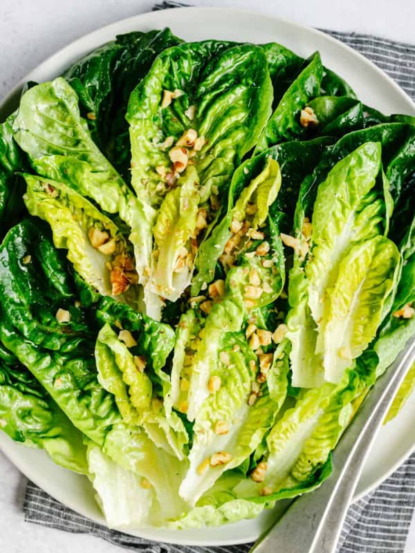 Little Gem Salad served on a round white platter and photographed from overhead.